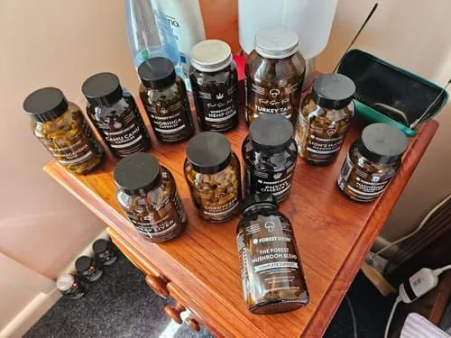 Customer photo by Peter M.: a collection of Forest Super Foods supplement jars on a wooden table